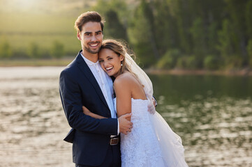 Happy wedding couple, portrait and hug by lake for romantic honeymoon getaway in nature. Man and...