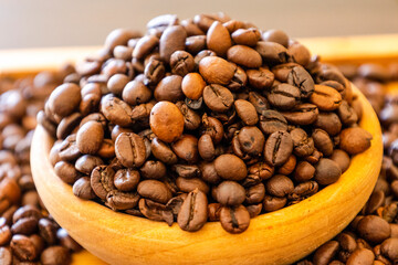 close up coffee beans in wooden bowl