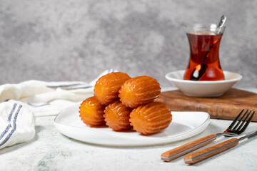 Tulumba dessert. Ramadan sweets. Traditional Turkish cuisine delicacies. Tulumba dessert with syrup on a gray background.