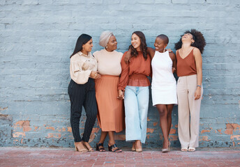 Laughing, diversity and a team of business black women outdoor on a blue brick wall for...