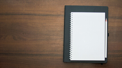 Notebook and pencil on a beautiful background in a photo studio