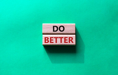 Do better symbol. Wooden blocks with words Do better. Beautiful green background. Business and Do better concept. Copy space.