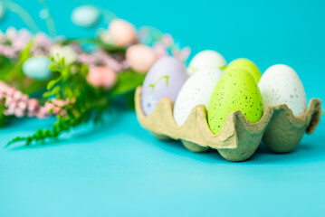 multi-colored painted Easter eggs on a blue background