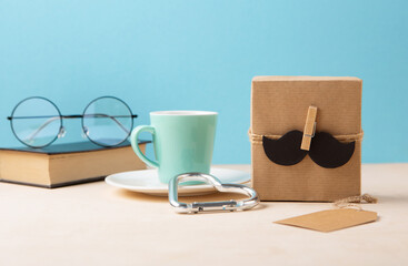 Fathers day Card with Gift Box, Moustache, Cup of Coffee and Glasses on Blue Background