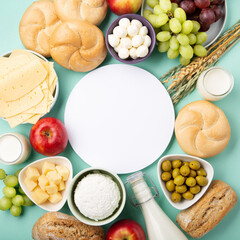 Jewish Shavuot Holiday Card. Dairy Products, Fruits, Cheese, Bread, Milk on Blue Mint Background.