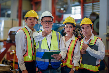 Header mentor and young employees trainee stand for operating machine looking see through camera monitor and point finger with angry serious mood. foreman team young engineer angry serious mood