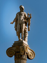 Statue of Apollo, ancient Greek god of fine arts, wearing a tunic and holding a lyre. Travel to Athens, Greece.