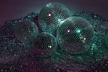 Shiny disco balls and foil fringe curtain indoors, color toned