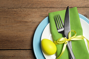 Festive table setting with painted egg and space for text, top view. Easter celebration