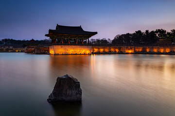 Donggung Palace and Wolji Pond in Banwolseong palace at late sunset in long exposure with lights on Gyeongju, South Korea.