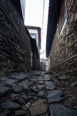 Narrow street in the old town of Bursa, Turkey. Old houses with stone walls.