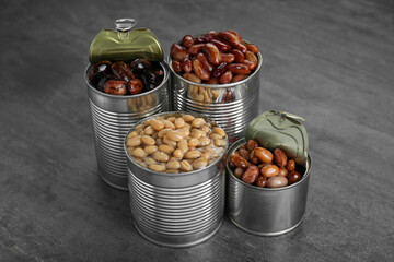 Tin cans with kidney beans on gray table
