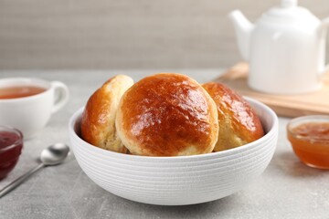 Tasty scones prepared on soda water on grey marble table, closeup