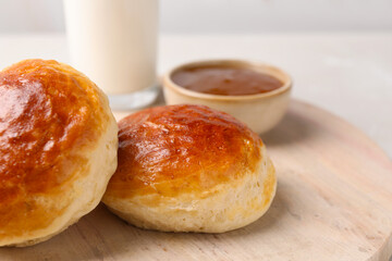 Freshly baked soda water scones on wooden table, closeup. Space for text