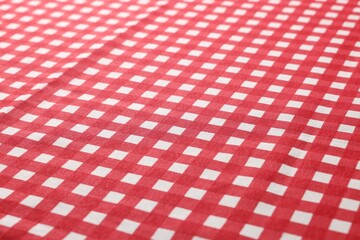 Red checkered tablecloth as background, closeup view