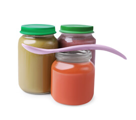 Glass jars with healthy baby food and spoon isolated on white