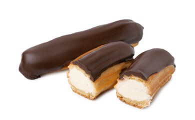 Cut and whole delicious eclairs covered with chocolate isolated on white