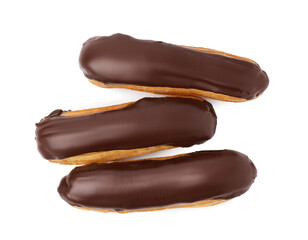 Delicious eclairs covered with chocolate isolated on white, top view