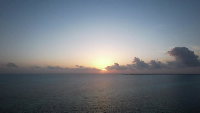 Sunrise fly over the waters of the Gulf of Mexico. Located in Cancun, Mexico. Aerial 4K drone video