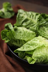 Fresh green romaine lettuces in bowl, closeup