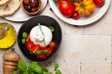 Burrata cheese, various tomatoes and olives