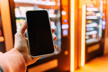 Close-up smartphone with blank display in male hand.