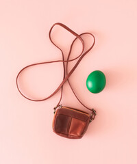 Easter egg and cute little leather bag or purse. Minimal Easter holiday design. Flat lay.