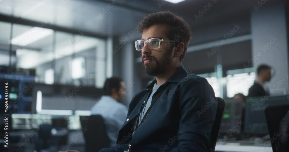 Aufkleber Handsome Indian Software Developer Working on Computer in a Technological Laboratory Environment. Young Man is Thoughtful at His Workplace, Drafting Research Ideas for an AI Development Blockchain