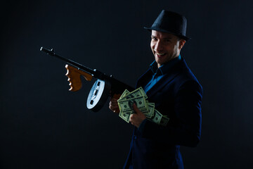Mature man in sunglasses with gun