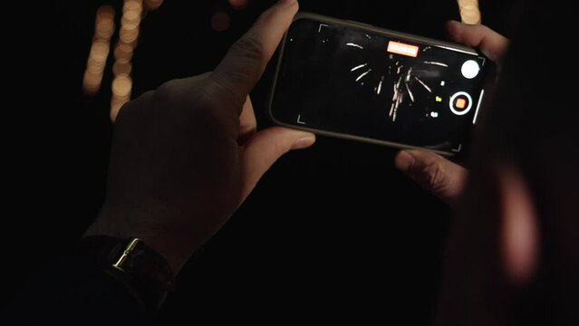 Close uf of the phone recording a video of fireworks. High quality 4k footage