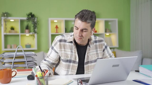 Home office worker working under time pressure.
Home office worker looking at his watch gets flustered and panics.
