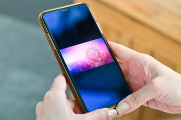 Hand holding smartphone checking your daily horoscope. Astrological zodiac horoscope Mobile...