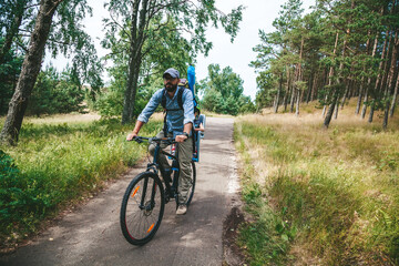 Fototapeta premium Father and his little child cycling through the woods