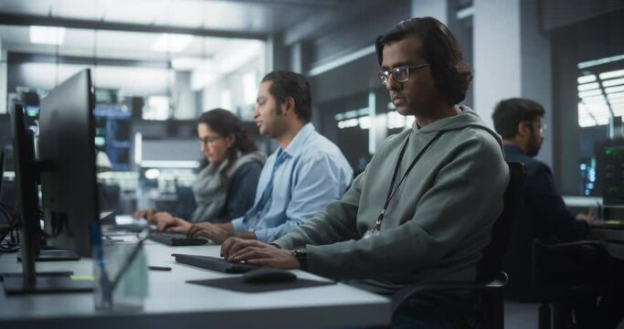 Group of Multicultural South Asian Men and Women Working in a Research Center, Collaborating and Discussing a Project, Using Computers to Write Software Code, Develop Artificial Intelligence Service