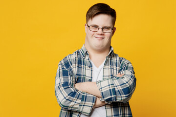 Young smiling satisfied man with down syndrome wearing glasses casual clothes look camera hold...
