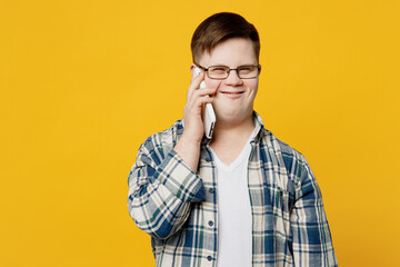 Young smiling cheerful happy fun man with down syndrome wear glasses casual clothes talk speak on...