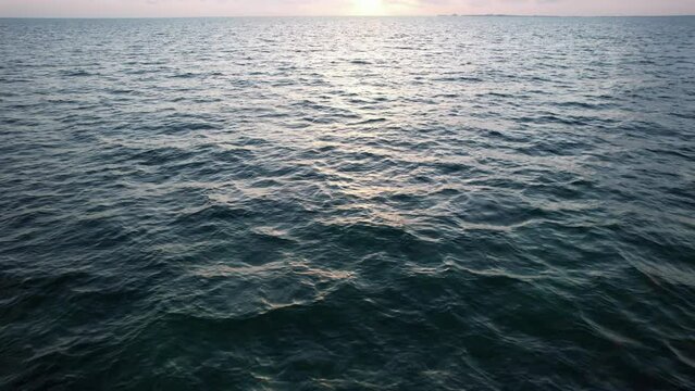 Sunset fly over the waters of the Gulf of Mexico. Located in Cancun, Mexico. Aerial 4K drone video