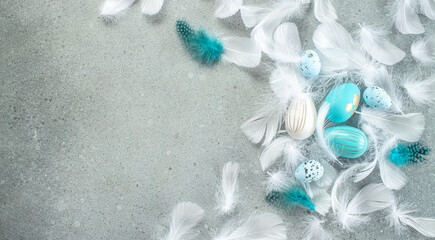 Easter composition. Easter eggs with feathers on gray background. Happy Easter card design. Long banner format. top view