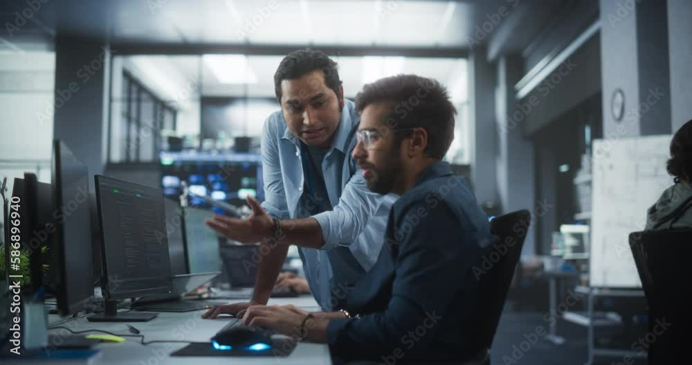Poster Creative Team of Indian Specialists Having a Conversation at a Workplace Next to Computer. Two Male Software Engineers Discussing a Software Code for Their Digital Blockchain Development Project