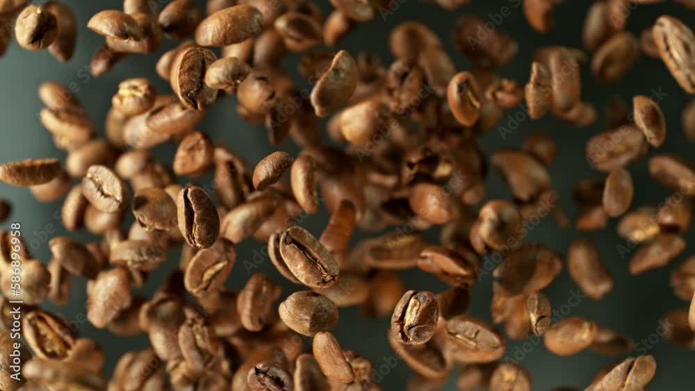 Poster super slow motion of rotating coffee beans on black background. filmed on high speed cinema camera, 
