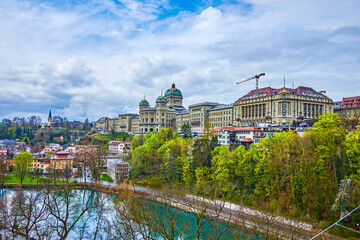Cityscape of Aare river bank with Bundeshaus (Federal Palace) building on the hill, Bern,...