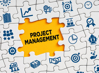 Project management concept. The word project management in a missing puzzle piece with business symbols.