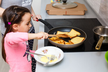 Cute child, beautiful Caucasian a little girl is cooking