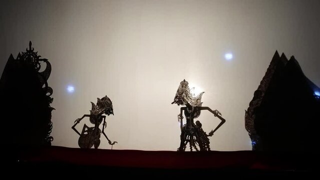 The silhouette of a puppet played by a puppeteer in a performance, HD video