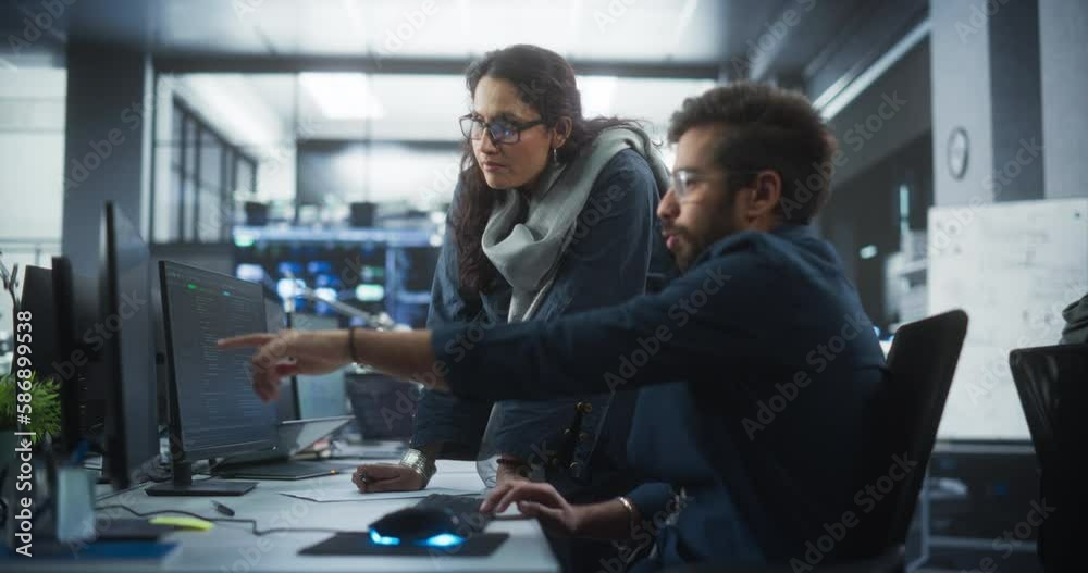 Poster Two Young Indian Colleagues Working in a Cyber Security Software Development Department. Young Manager Updating Software Developer on the Artificial Intelligence Safety Project