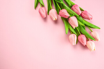 Spring tulip flowers on pastel pink background. Greeting for Womens or Mothers Day