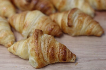 Dish of croissants of a catering in wood background