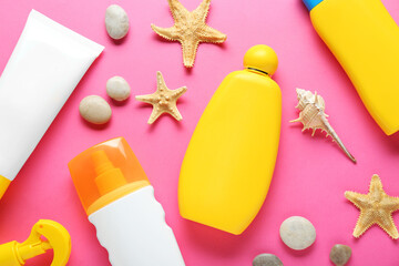 Different suntan products, starfishes and stones on pink background, flat lay