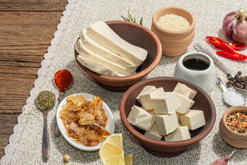 Fototapeta na wymiar Set of ingredients for preparation Tofu. Fresh diced cheese, spices, herbs and soy sauce