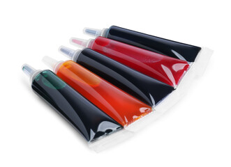 Tubes with different food coloring on white background